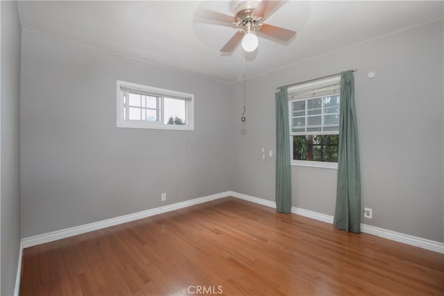 spare room with hardwood / wood-style floors and ceiling fan