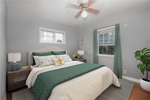 bedroom with ceiling fan and hardwood / wood-style floors