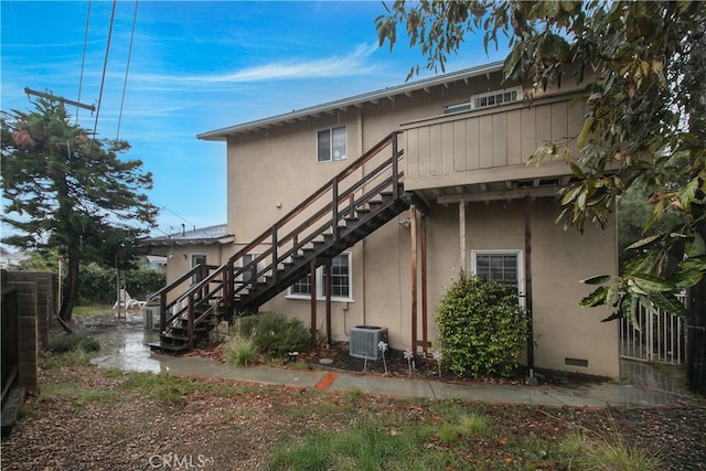 rear view of property featuring central AC unit