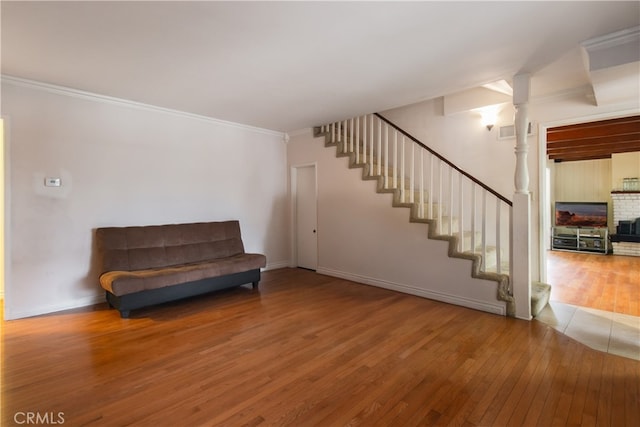 unfurnished room with ornamental molding, ornate columns, and hardwood / wood-style floors