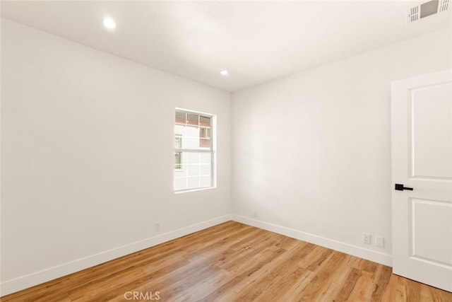 unfurnished room featuring baseboards, recessed lighting, visible vents, and light wood-style floors