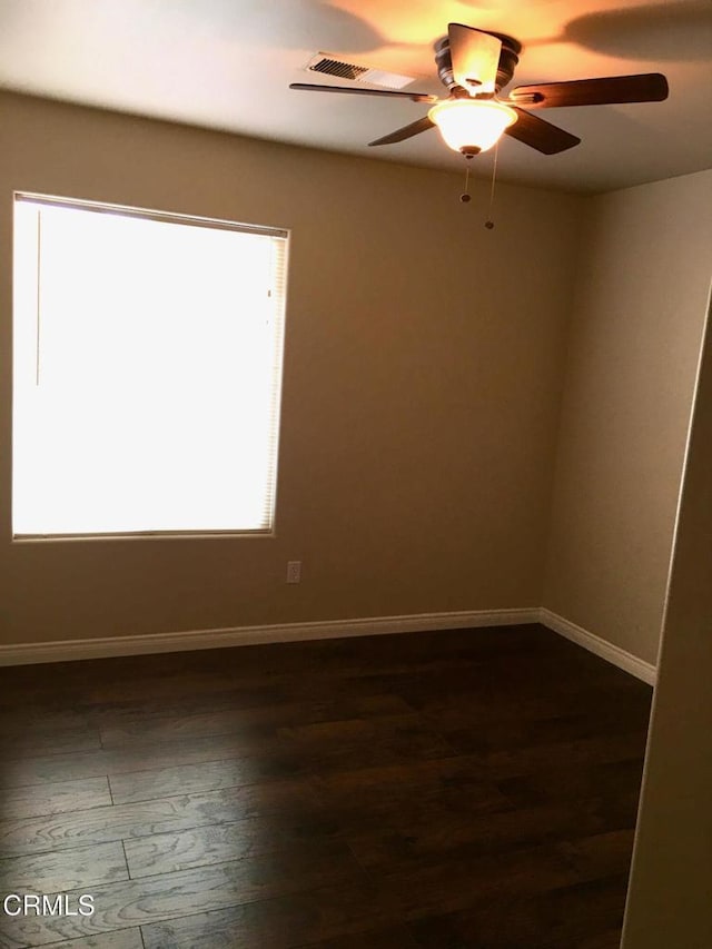 unfurnished room with dark hardwood / wood-style floors and ceiling fan