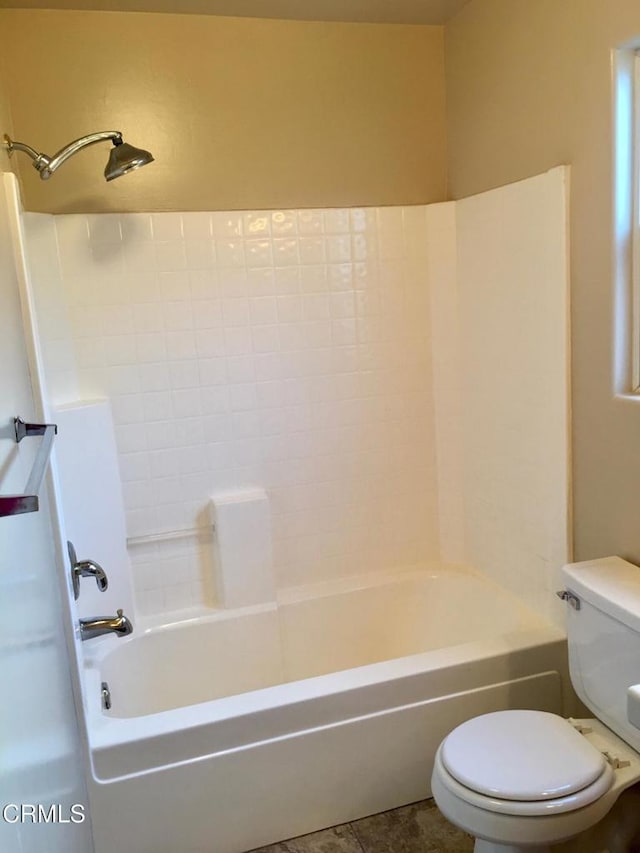 bathroom featuring toilet, tub / shower combination, and tile patterned flooring