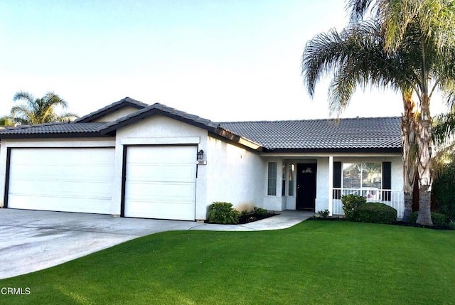 ranch-style house with a garage, a front yard, and covered porch