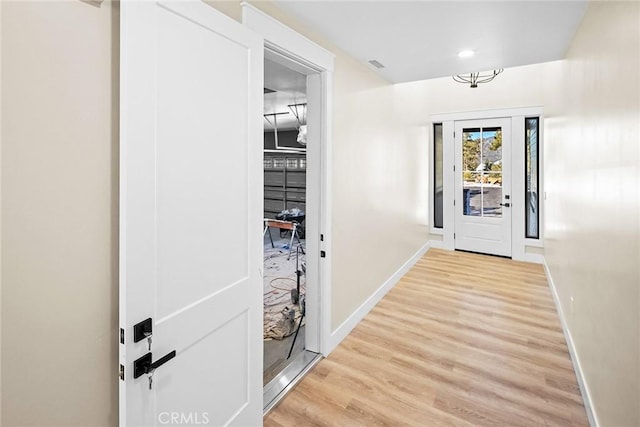 doorway to outside with light wood-type flooring