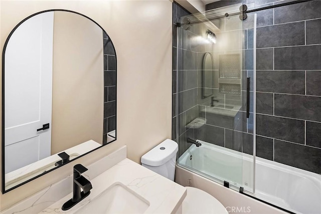 full bathroom with toilet, vanity, and shower / bath combination with glass door