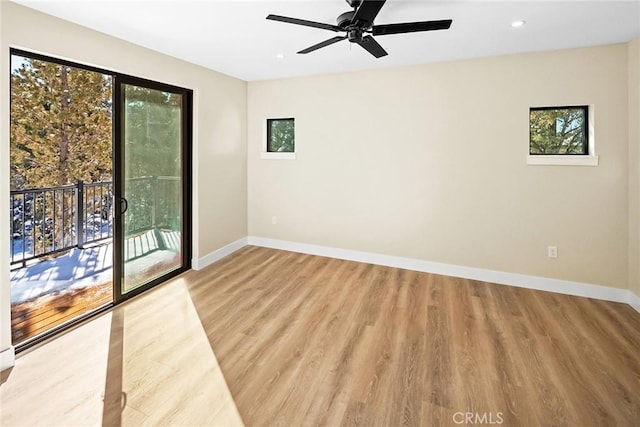empty room with ceiling fan and light wood-type flooring