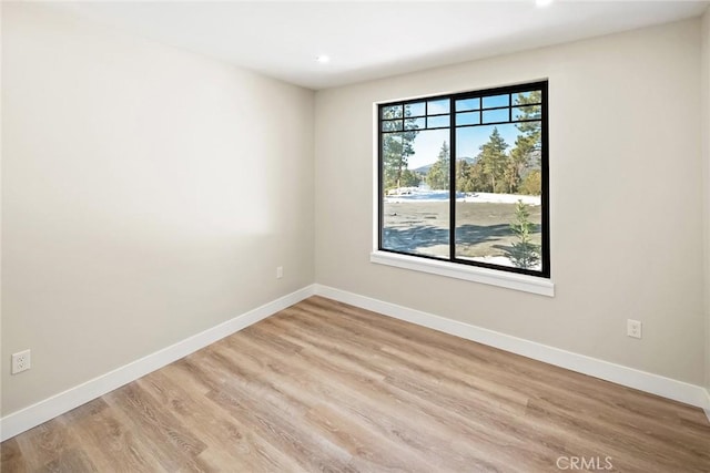 unfurnished room with light hardwood / wood-style floors