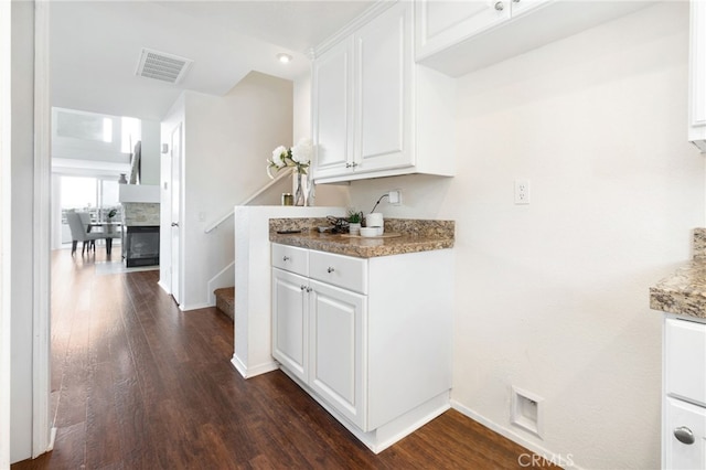 kitchen with white cabinetry and dark wood-type flooring