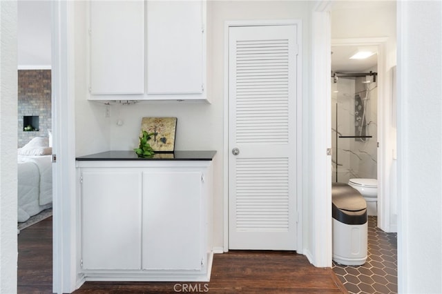 interior space with hardwood / wood-style floors and toilet