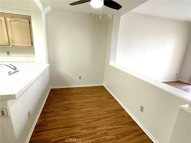 unfurnished dining area featuring dark hardwood / wood-style flooring and ceiling fan