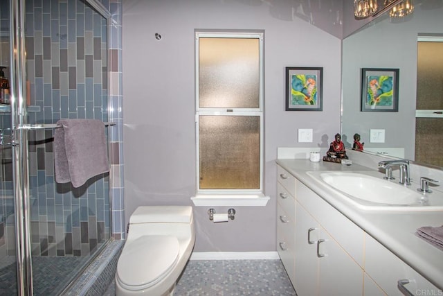 bathroom with vanity, toilet, and a shower with shower door