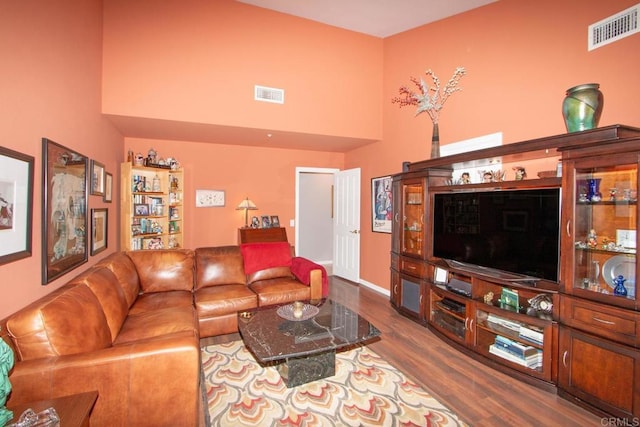 living room with a high ceiling and hardwood / wood-style floors