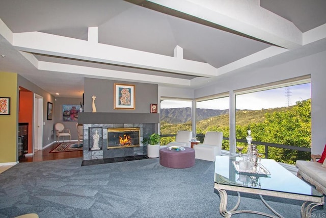 interior space featuring a mountain view, carpet flooring, high vaulted ceiling, and a fireplace