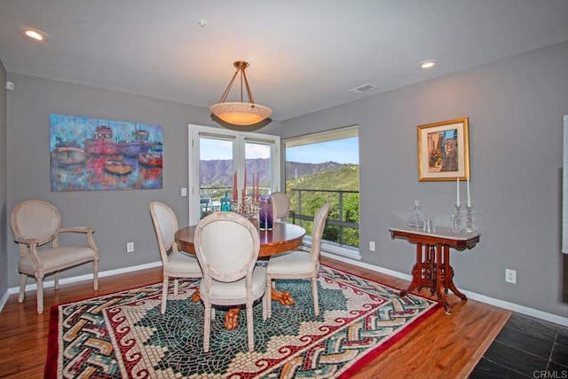 dining area featuring a mountain view and dark hardwood / wood-style floors