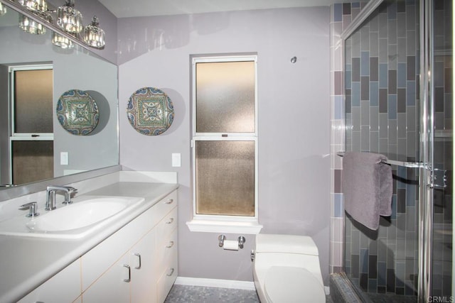 bathroom featuring an enclosed shower, vanity, and toilet