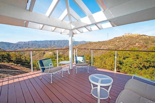 wooden terrace with a mountain view and a pergola