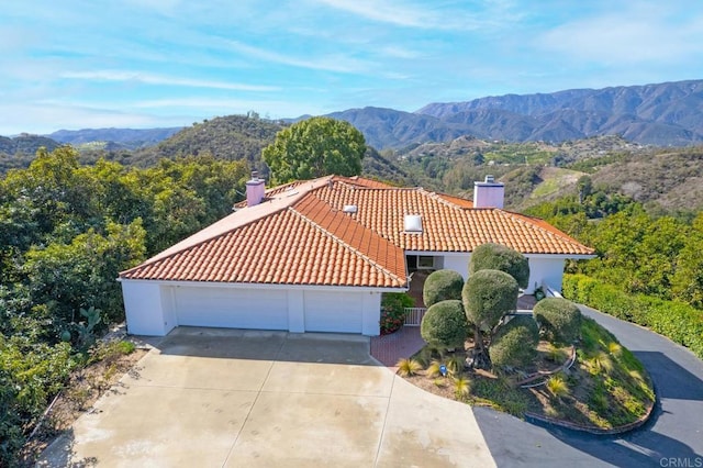 view of front of home featuring a garage and a mountain view