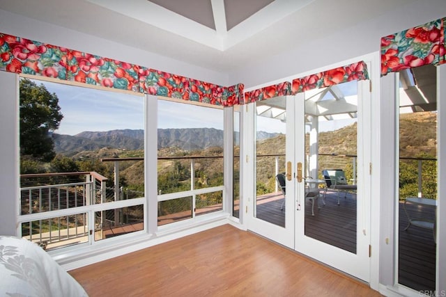 unfurnished sunroom with a mountain view