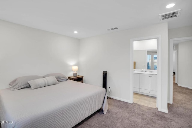 carpeted bedroom with ensuite bathroom