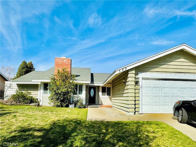 ranch-style house featuring a garage and a front lawn