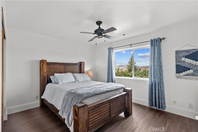 bedroom with dark hardwood / wood-style flooring and ceiling fan