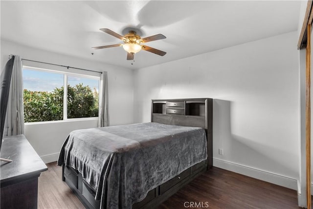 bedroom with ceiling fan and dark hardwood / wood-style floors