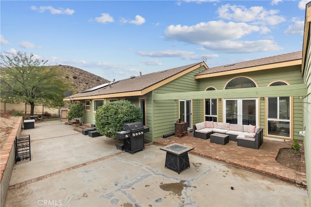 rear view of house with a mountain view, an outdoor hangout area, and a patio area