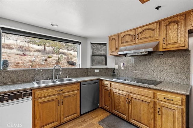 kitchen with sink, dishwasher, light hardwood / wood-style floors, black electric stovetop, and decorative backsplash