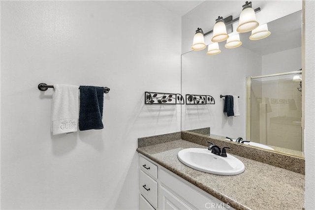 bathroom featuring vanity and a shower with door