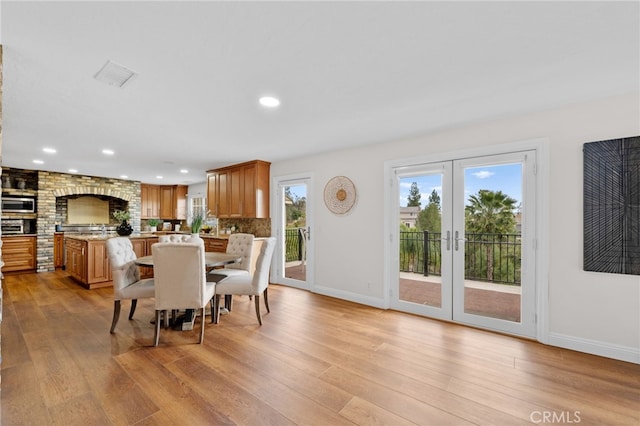 dining room with recessed lighting, visible vents, baseboards, light wood-style floors, and french doors