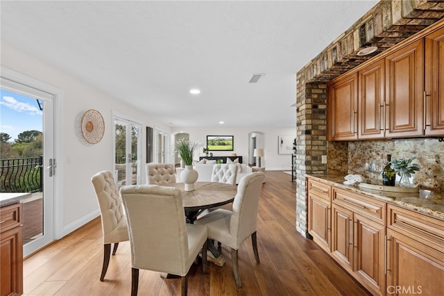 dining area with recessed lighting, baseboards, and light wood finished floors