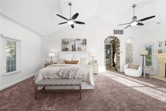 bedroom with a fireplace with raised hearth, carpet floors, multiple windows, and visible vents