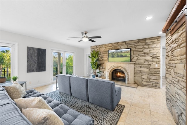 living room featuring a ceiling fan, recessed lighting, a fireplace, and baseboards