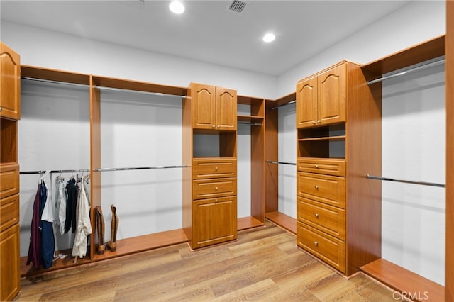 spacious closet with light wood finished floors and visible vents