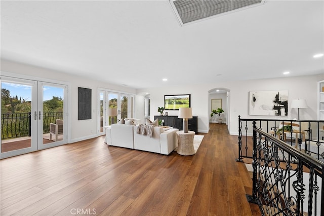 living area featuring visible vents, wood finished floors, and french doors