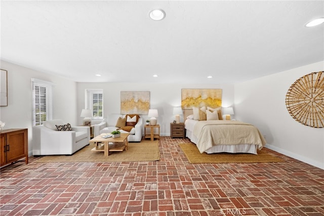 bedroom featuring brick floor, recessed lighting, and baseboards