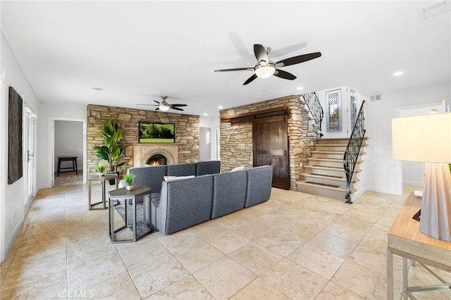 living area with recessed lighting, visible vents, baseboards, stairs, and a lit fireplace