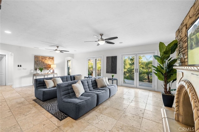 living area with a textured ceiling, french doors, recessed lighting, and baseboards