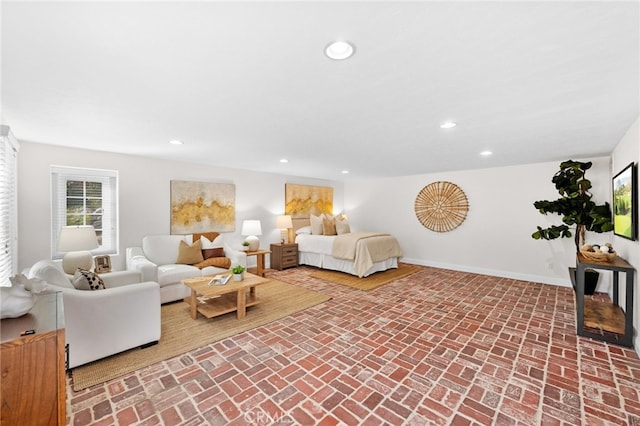 living area featuring brick floor, baseboards, and recessed lighting