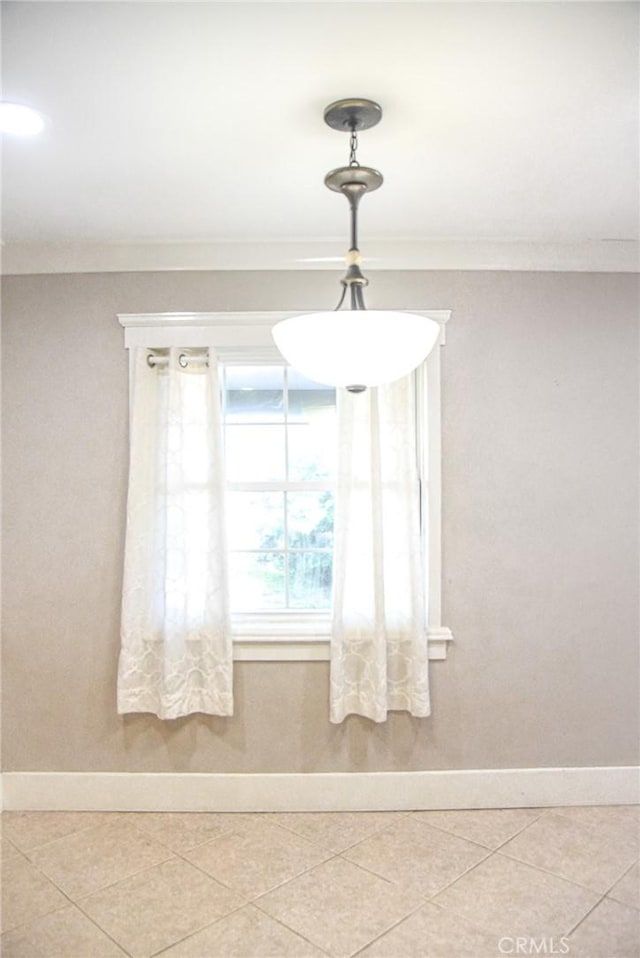 interior details featuring ornamental molding and baseboards