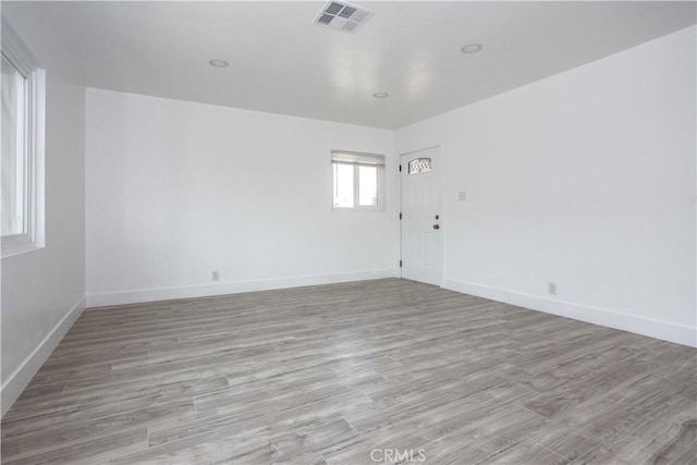 unfurnished room with light hardwood / wood-style floors