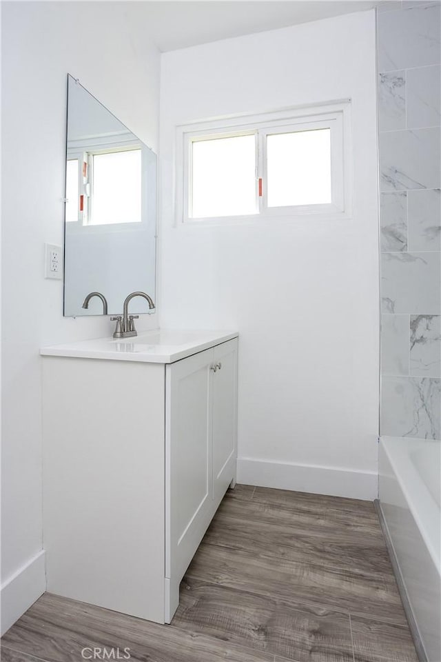 bathroom featuring vanity and hardwood / wood-style floors