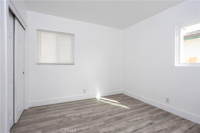 unfurnished bedroom featuring light hardwood / wood-style floors and a closet