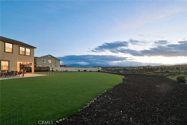 view of yard with a mountain view and a patio