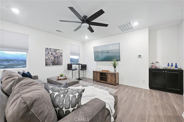 living room with ceiling fan and light hardwood / wood-style floors