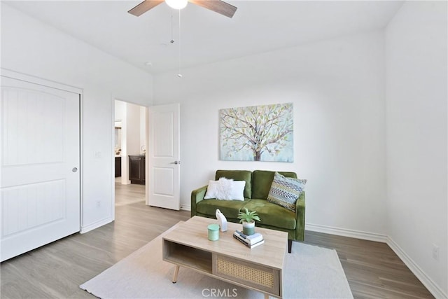 living room featuring wood-type flooring and ceiling fan