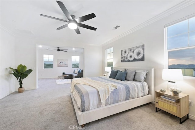 carpeted bedroom featuring crown molding and ceiling fan