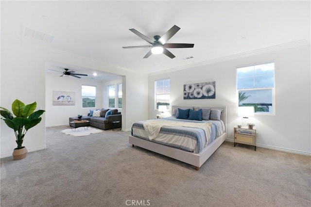 bedroom with crown molding, ceiling fan, and light carpet