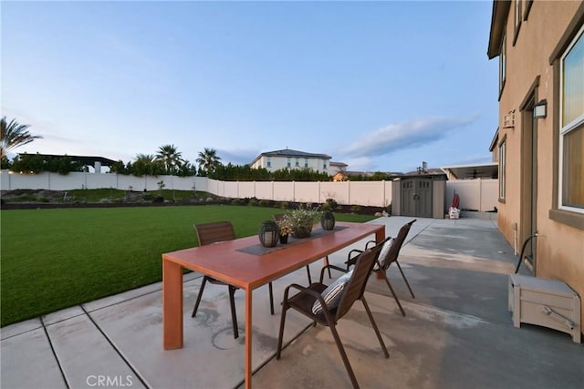 view of patio featuring a storage shed and a water view